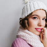 Close Up Portrait Of Refined Curly Woman In White Hat. Ecstatic European Girl With Beautiful Eyes Posing In Cute Scarf..